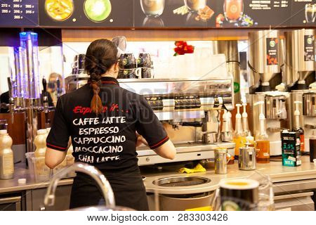 St. Petersburg, Russia - Dec 12, 2018: Girl Barista Making Cup Coffee In Coffeeshop Company On Cafe 