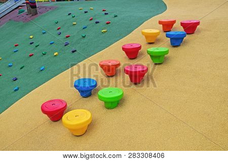 Children Playground With Multi-colored Plastic Stumps For Climbing And Jumping Covered With A Rubber