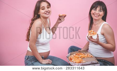 Nutrition Concept, Pregnant Women Eating Pizza On A Pink Background