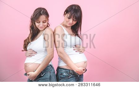 Maternity Concept, Two Pregnant Women With An Open Tummy