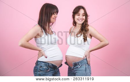 Maternity Concept, Two Pregnant Women With An Open Tummy