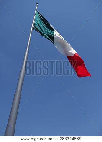 Beautiful National Maxican Flag On Beach At Bay Of Pacific Ocean In Acapulco City In Mexico With Tre