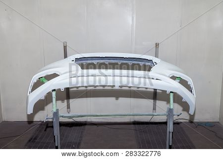 Repair Of The Rear Bumper Of A White Car After An Accident With The Help Of Multi-colored Putty In A