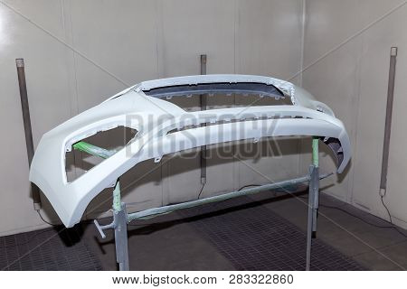 Repair Of The Rear Bumper Of A White Car After An Accident With The Help Of Multi-colored Putty In A