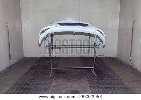 Repair Of The Rear Bumper Of A White Car After An Accident With The Help Of Multi-colored Putty In A