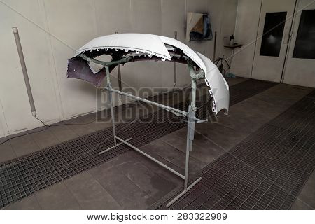 Repair Of The Rear Bumper Of A White Car After An Accident With The Help Of Multi-colored Putty In A