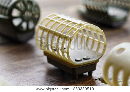 Necessary Accessories For Feeder Fishing On A Wooden Board. Feeder Feeders Side View.