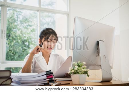Accounting Planning Budget Report File Concept: Asian Business Woman Offices Check Working For Docum