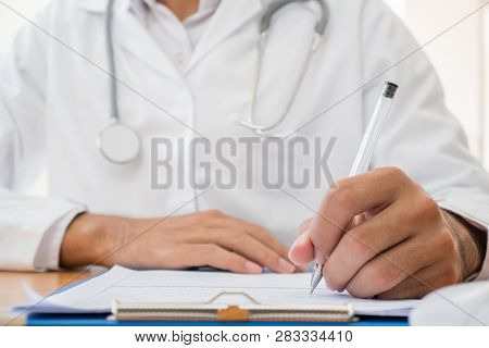 Healthcare Medical Expenses Concept, Hands Doctor's Writing And Working On Prescription Clipboard Wi