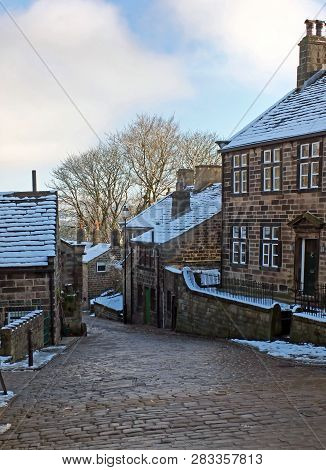 A Scenic View Of The Main Street In The Village Of Heptonstall In West Yorkshire With Snow Covering 