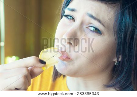 Beautiful Girl Eating Sour Lemon. Puckery From Sour