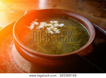 Iet Sorrel Soup With Egg. On A Wooden Table.