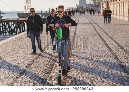 Lisbon, Portugal - 12/28/18: Tourist Kid With Rented Electric Scooter. California Design Scooters In