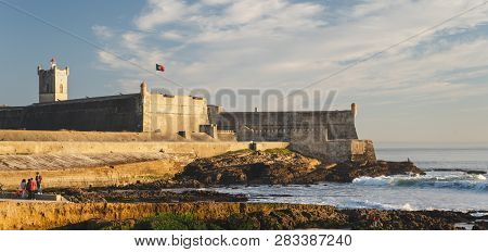 Carcavelos, Portugal - 12/31/18: Saint Julian Fortress With Lighthouse Tower, Beach (praia) Of Carca