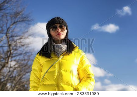 A Chinese Woman Wearing A Yellow Winter Jacket Looking At The Camera On A Cold Winter Day In West St