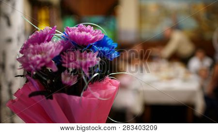 Bunch Of Red And Blue Asters In In A Pink Wrapper On Blur Background