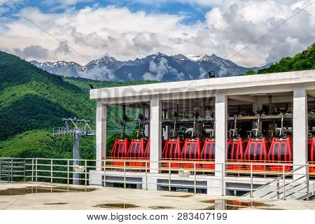 Sochi, Russia - May 23, 2014: Scenic Sunny Landscape Of Parked Red Passenger Cabins At Russki Gorki 
