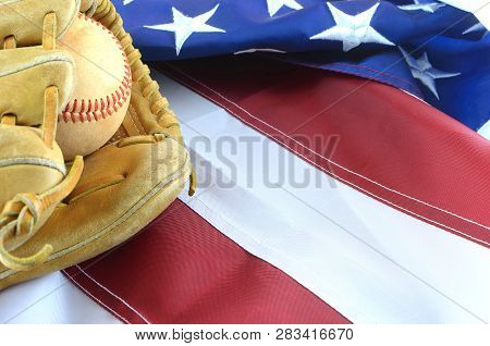 Closeup Of Worn Baseball And Mitt On A Us Flag Background, Great For Americas Favorite Pasttime. Cop