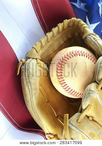 Closeup Of Worn Baseball And Mitt On A Us Flag Background, Great For Americas Favorite Pasttime. Ver