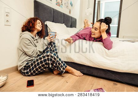 Roommates Having Much Fun While Talking In The Morning
