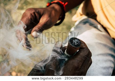 Varanasi India November 19, 2018 View Of A Unknown Sadhu Smoking A Chillum In The Streets Of Varanas