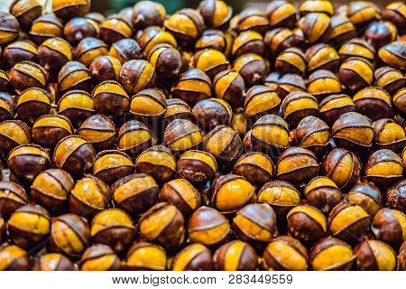 Bunch Of Roasted Chestnuts At Street Wendor. Roasted Chestnuts, Street Food