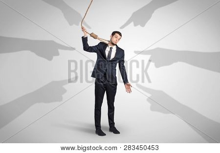 Young businessman trying to suicide with pointing hands concept