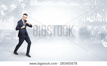 Young suited karate trainer doing karate tricks on the top of a metropolitan city