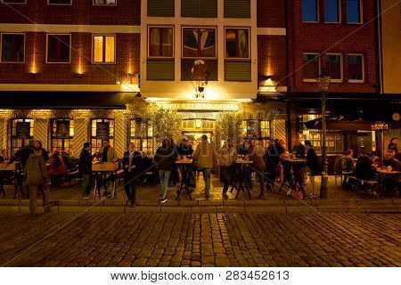 DUSSELDORF, GERMANY - CIRCA SEPTEMBER, 2018: people drink beer at a bar in Dusseldorf.