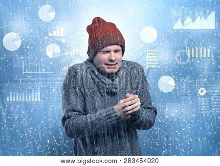 Young businessman shivering with graphs, reports and chart concept
