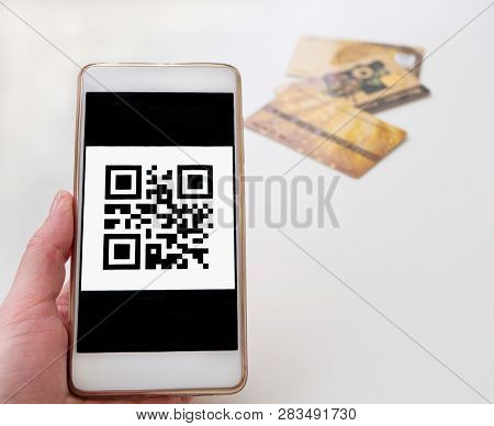 Barcode Close Up. Qrcode On The Phone And Three Credit Cards On The Background