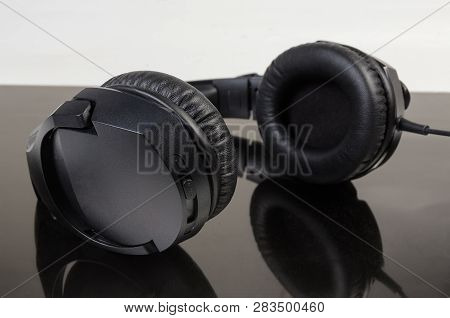 Black Wired High-fidelity Headset With Full Size Headphones Close-up At Selective Focus On A Dark Re