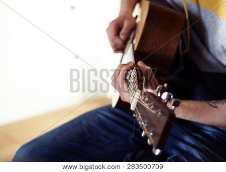 The Performer Plays A Wooden Acoustic Guitar On A Nice Sunny Day