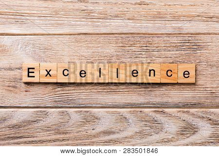 Excellence Word Written On Wood Block. Excellence Text On Wooden Table For Your Desing, Concept