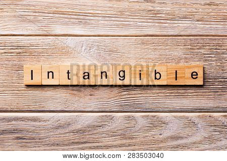 Intangible Word Written On Wood Block. Intangible Text On Wooden Table For Your Desing, Concept