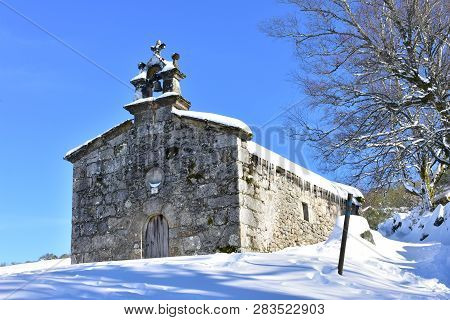 Piornedo, Ancares, Lugo Province, Galicia, Spain. San Lorenzo Hermitage With Snow, Ice And Icicles. 