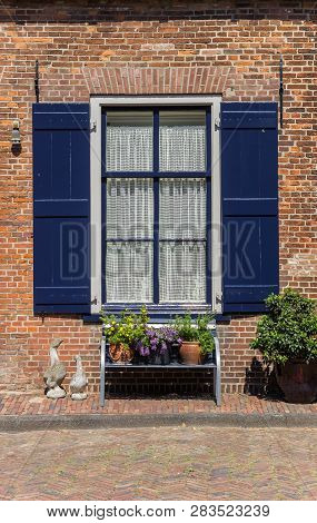 Bench With Flowers In Front Of A Window In Doesburg, Holland