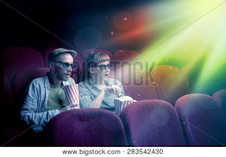 Teenager couple cuddling and watching the climax part of the movie