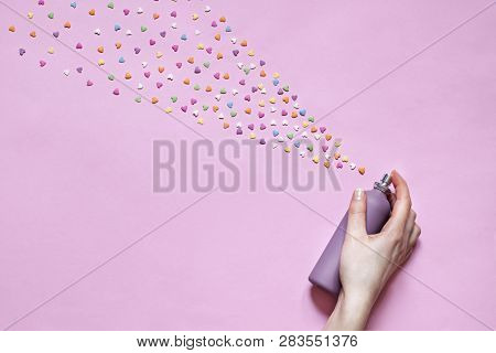 Abstract Pink Valentines Day Flat Lay. Top View Card. Womans Hand Is Spraying Little Hearts
