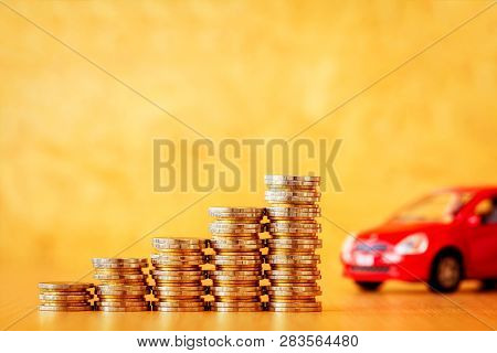 Stack Coin With Growing For Collect Interest And Red Car Model Put On The Desk In The Office, Loan A