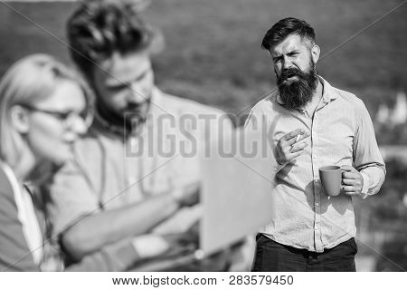 Colleagues Working Laptop, Boss Smoking While Coffee Break On Background. Workaholics Concept. Coupl