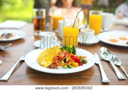 Omelet With Pepper, Cucumber, Bakon And Salad On The Table Outdoors