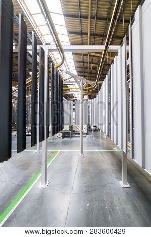 Powder Coating Line. Metal Panels Are Suspended On An Overhead Conveyor Line. Painting Products In A