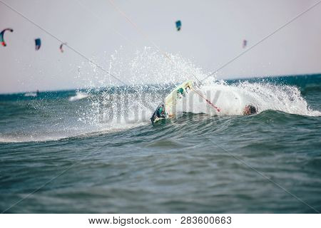 Professional Kiter Makes The Difficult Trick On A Beautiful Background. Kitesurfing Kiteboarding Act