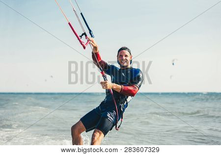 Professional Kiter Makes The Difficult Trick On A Beautiful Background. Kitesurfing Kiteboarding Act