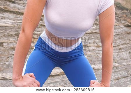 Flat Belly Girl During Diaphragmatic Breathing Exercises Bodyflex On The Rock Background. Belly Clos