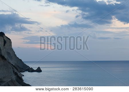 Beautiful Coastline With Cliffs In Corfu, Greece. Sunset View In Peroulades Region.