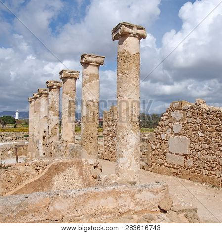 Roman Walls And Columns In The House Of Theseus In Paphos Cyprus With The Historic Lighthouse In The