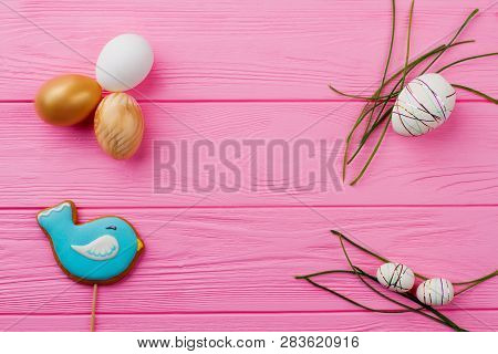 Easter Eggs And Grass On Wooden Background. Easter Decorative Eggs, Bird Shaped Cookie And Copy Spac