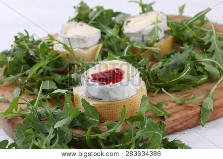 Cheese Saint-mor-de-touren With Raspberry Jam On White Wooden Background